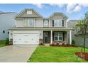 Charming two-story home featuring stone accents, a well-manicured lawn, and a two-car garage at 5115 Heathland Dr # 47, Charlotte, NC 28215