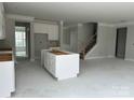 Open-concept kitchen with a large island and white cabinets, perfect for entertaining and modern living at 5115 Heathland Dr # 47, Charlotte, NC 28215
