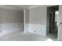 Spacious living area showcasing classic white trim, molding, and wainscoting details for an elegant touch at 5115 Heathland Dr # 47, Charlotte, NC 28215