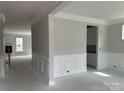 Bright living room featuring white trim, molding, and wainscoting details, offering a classic, elegant touch at 5115 Heathland Dr # 47, Charlotte, NC 28215