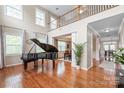 Spacious living area with hardwood floors, staircase, and an open view to the dining room at 8905 Valleymoon Ln, Charlotte, NC 28214