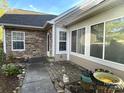 Rear view showing patio and stone exterior at 9013 Trellis Pointe Blvd, Charlotte, NC 28227