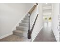 Hallway with staircase featuring carpeted steps and white railings in a modern-style home at 102 Obadiah Ct, Troutman, NC 28115