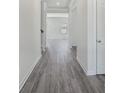 Bright hallway featuring luxury vinyl plank flooring, white trim, and neutral paint at 107 Obadiah Ct, Troutman, NC 28115