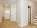 Bright foyer featuring wood flooring, closet, and door to another room at 149 Halite Ln, Waxhaw, NC 28173