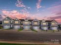 A row of modern, new construction townhomes at sunset showcase uniformity at 149 Halite Ln, Waxhaw, NC 28173