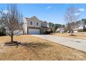 Inviting two-story home featuring stone accents and a two-car garage with a well-manicured lawn at 8007 April Ln, Matthews, NC 28104