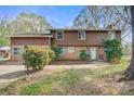 Attractive exterior featuring brick and wood accents with mature landscaping and a well-maintained lawn at 841 12Th Nw Ave, Hickory, NC 28601