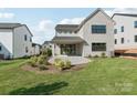 Wide angle shot of a home's backyard showing a manicured lawn and patio at 15008 Brownleigh Ln # 29, Huntersville, NC 28078