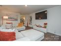 Bright and open living room space with a large TV and stylish decorations at 318 Kingsford Dr, Stanley, NC 28164