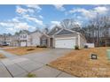 Attractive single-Gathering home features stone accents, a two-car garage, and a landscaped yard at 654 Saddlebred Ln, Locust, NC 28097