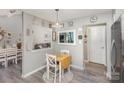 Cozy dining area features a light fixture and an open view into the living room at 11800 Five Cedars Rd, Charlotte, NC 28226