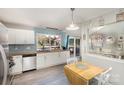 Bright kitchen features white cabinetry, butcher block counters, stainless steel appliances, and an open dining area at 11800 Five Cedars Rd, Charlotte, NC 28226