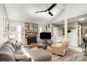 Inviting living room showcases stone fireplace, vaulted ceiling, modern ceiling fan and recessed lighting at 11800 Five Cedars Rd, Charlotte, NC 28226