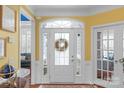 Bright foyer with transom window over the front door and decorative wreath at 2106 Yellowstone Dr, Fort Mill, SC 29707