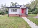 White ranch home with red door and brick foundation at 41 Calhoun St, Great Falls, SC 29055