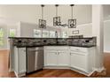 Modern kitchen with white cabinets, stainless steel appliances, and decorative backsplash at 13929 Tilesford Ln, Huntersville, NC 28078