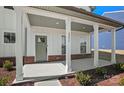 Inviting front porch with white columns, brick accents, and a stylish entrance door at 2237 Millennium Dr # 012, Lancaster, SC 29720