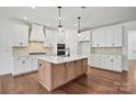 Modern kitchen with white cabinets, a center island, and stainless steel appliances at 2237 Millennium Dr # 012, Lancaster, SC 29720