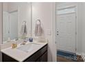 Clean half bathroom featuring a modern vanity, neutral colors, and a mirror at 208 Waterlynn Ridge Rd # B, Mooresville, NC 28117