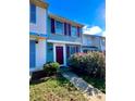 Charming townhome with colorful shutters and a well-maintained front garden with flowering bushes at 7324 Pebblestone Dr # F, Charlotte, NC 28212