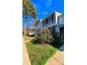 Townhome exterior featuring a well-manicured lawn and vibrant flower bushes at 7324 Pebblestone Dr # F, Charlotte, NC 28212