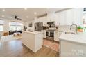 Modern kitchen with stainless steel appliances, white cabinets, and a central island at 544 Billingsley Rd, Charlotte, NC 28211