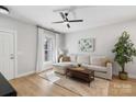 Sunlit living room featuring a comfortable sectional sofa and stylish decor at 8225 Ballymore Ct, Huntersville, NC 28078