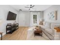 Cozy living room with a large TV, comfortable seating, and natural light at 8225 Ballymore Ct, Huntersville, NC 28078
