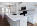 Modern kitchen with white cabinets and quartz countertops at 2212 Noble Townes Way, Charlotte, NC 28262