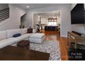 Open living room with hardwood floors and view into kitchen at 2535 Irwin Stream Rd, Charlotte, NC 28208