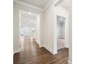 Bright hallway with hardwood flooring, leading to living area and carpeted bedroom at 9924 Manor Vista Trl, Kannapolis, NC 28027