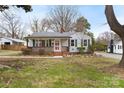 Charming single-story home with a welcoming front porch and a well-maintained yard with mature trees at 27 Sw Barbee Rd, Concord, NC 28027