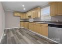 Bright kitchen featuring wood cabinets, neutral countertops, and durable laminate flooring at 27 Sw Barbee Rd, Concord, NC 28027