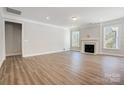 Spacious living room with hardwood floors, a fireplace, and large windows at 4021 Grace Pointe Dr # 104, Wesley Chapel, NC 28079