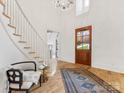 Welcoming foyer with a staircase, a view of the front door, and beautiful hardwood floors at 6040 Oxfordshire Rd, Waxhaw, NC 28173