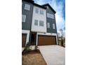 Contemporary townhome with a two-car garage, siding, and a well-maintained front lawn at 7928 Cedarsmith Ct, Charlotte, NC 28217