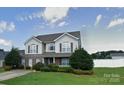Well-maintained home with mature landscaping and manicured lawn at 125 Mallory Tai Dr, Lincolnton, NC 28092