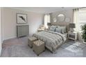 Inviting neutral-toned main bedroom with a plush bed, soft carpet, and natural light at 1602 Village Grove Ln, Monroe, NC 28110