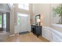Bright foyer with soaring ceilings, white trim, and stylish console table with decorative accents at 9618 Belloak Ln, Waxhaw, NC 28173