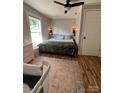 Comfortable bedroom with a queen bed, modern furniture, and a light fixture, creating a warm ambiance at 2100 Temple St, Kannapolis, NC 28081