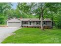 Ranch home with attached garage and driveway, surrounded by mature trees at 2109 Rock Springs Cir, Denver, NC 28037