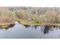 Aerial view of a property with a gazebo and pond at 100 Steffey Ln, Taylorsville, NC 28681