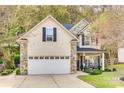 Two story house with stone accents, large garage, and landscaped front yard at 2824 Huckleberry Hill Dr, Fort Mill, SC 29715