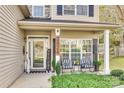 Inviting front porch with rocking chairs and well-maintained landscaping at 2824 Huckleberry Hill Dr, Fort Mill, SC 29715