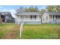 A cozy home with a inviting front porch and classic architectural details at 408 E Washington Ave, Bessemer City, NC 28016