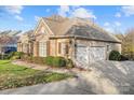 Spacious home with an attached two-car garage, well-manicured front yard, and charming architectural details at 14700 Old Vermillion Dr, Huntersville, NC 28078