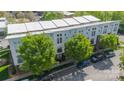 Overhead shot of modern townhomes with white roofs, mature trees, and convenient parking at 947 Warren Burgess Ln, Charlotte, NC 28205