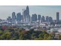 Scenic skyline view featuring a vibrant cityscape and lush green trees in the foreground at 947 Warren Burgess Ln, Charlotte, NC 28205