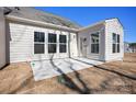 Back of house with small patio, freshly seeded yard, and view of neighborhood at 1065 Kinship Dr # 080, Lancaster, SC 29720